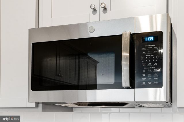 a living room with a fireplace and a window