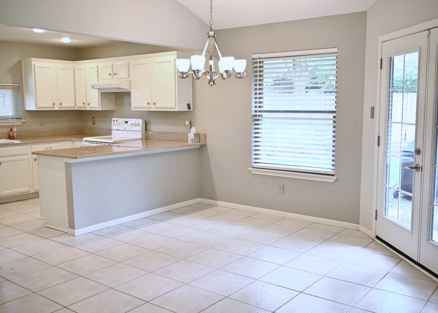 10207 Wayward Wind Lane Houston, TX 77064 - Photo 11 of 35 a kitchen with kitchen island white cabinets and window