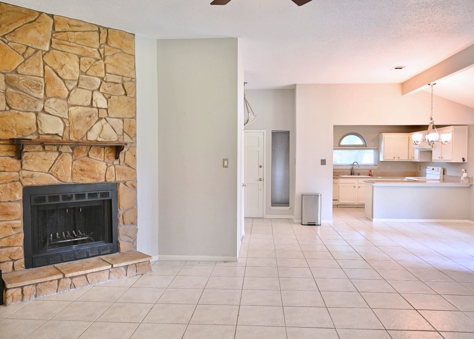 10207 Wayward Wind Lane Houston, TX 77064 - Photo 13 of 35 a large white kitchen with cabinets and a fireplace