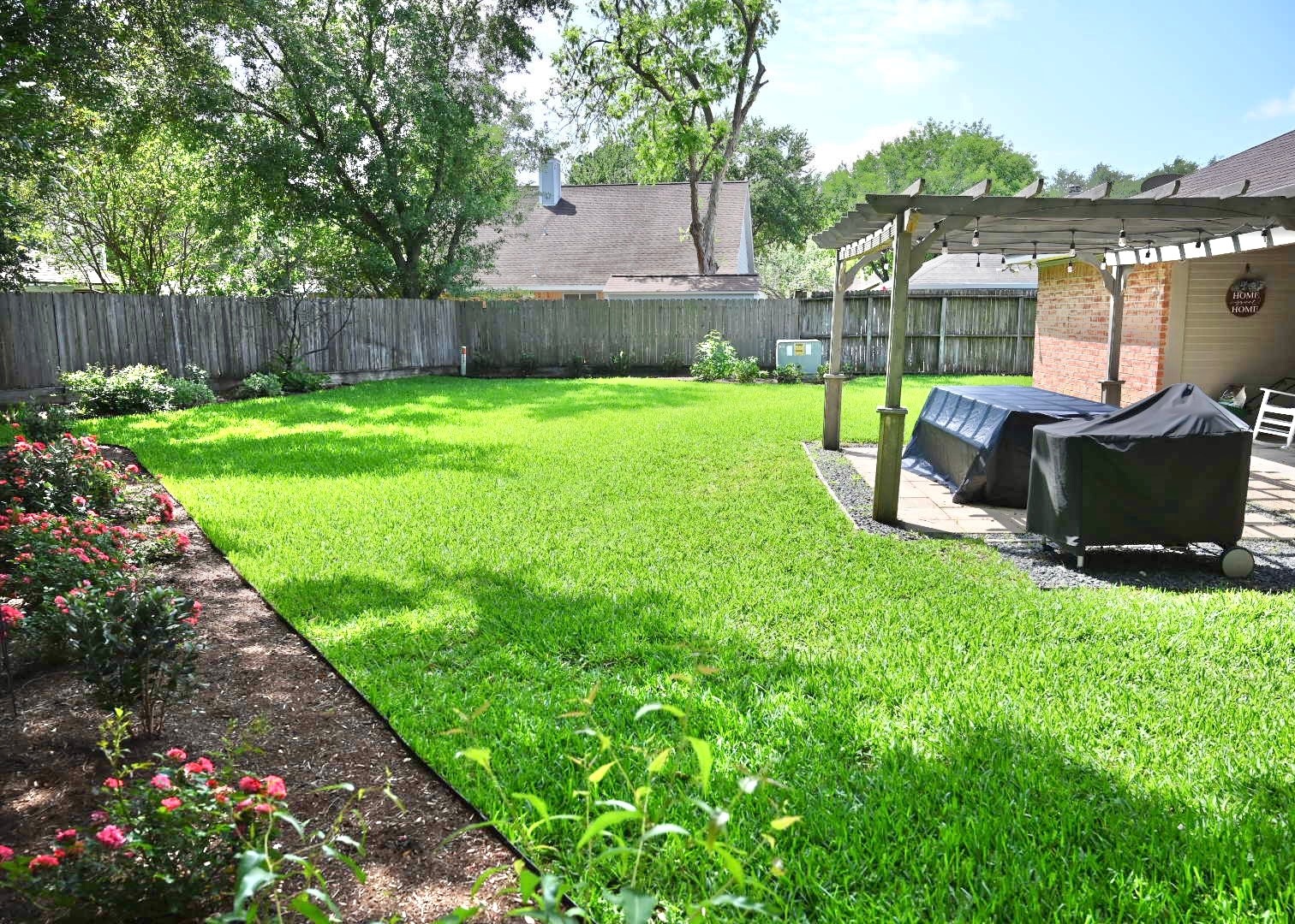 10207 Wayward Wind Lane Houston, TX 77064 - Photo 2 of 35 a view of a garden with a bench in the garden