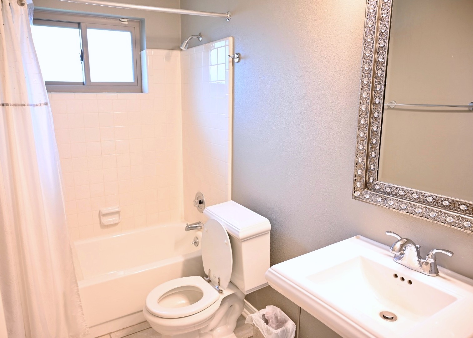 10207 Wayward Wind Lane Houston, TX 77064 - Photo 26 of 35 a bathroom with a sink a toilet and shower curtain