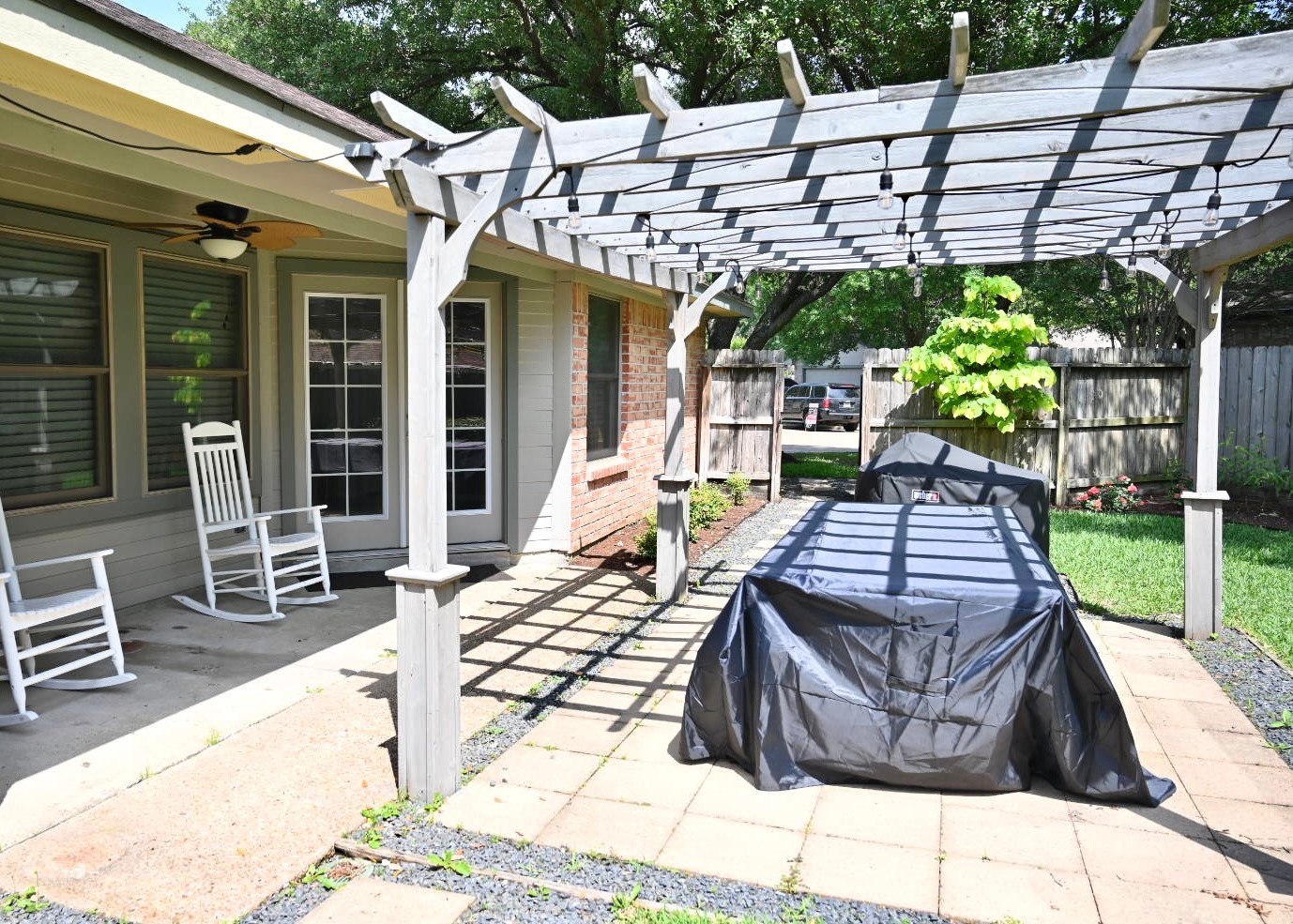 10207 Wayward Wind Lane Houston, TX 77064 - Photo 31 of 35 a view of a patio with table and chairs potted plants with wooden floor and fence