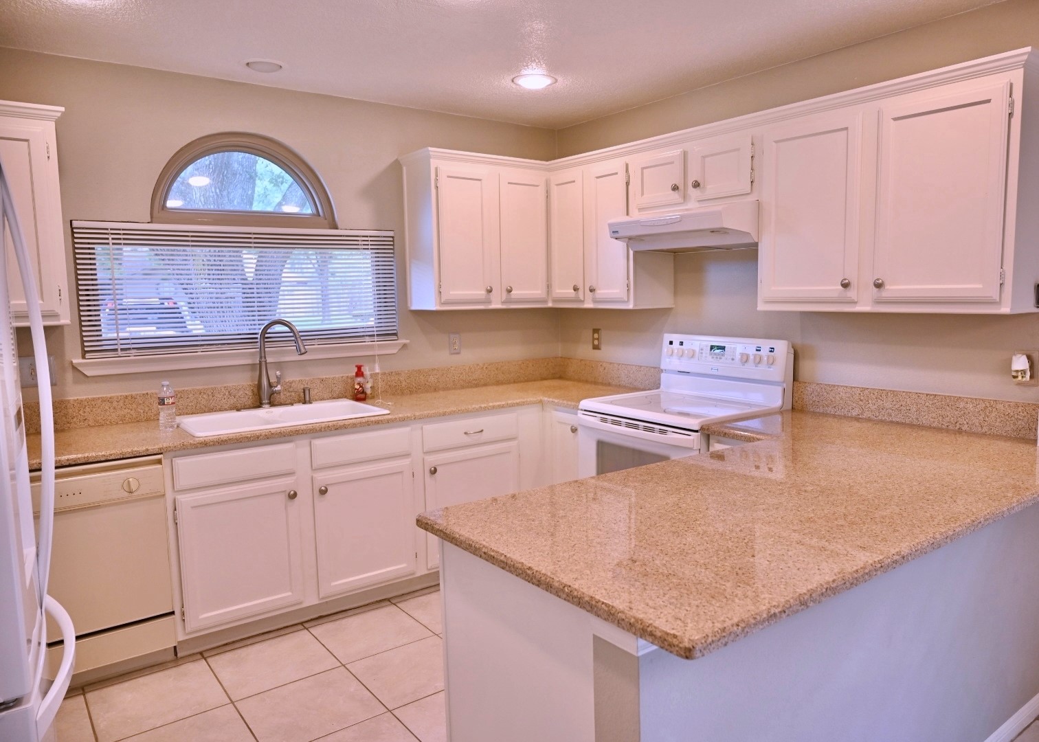 10207 Wayward Wind Lane Houston, TX 77064 - Photo 6 of 35 a kitchen with a sink a stove and cabinets