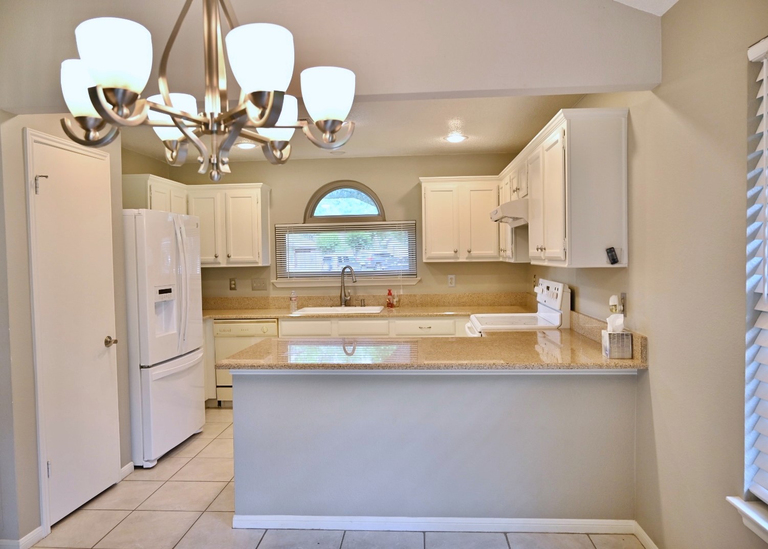 10207 Wayward Wind Lane Houston, TX 77064 - Photo 7 of 35 a view of a kitchen with a sink and chandelier