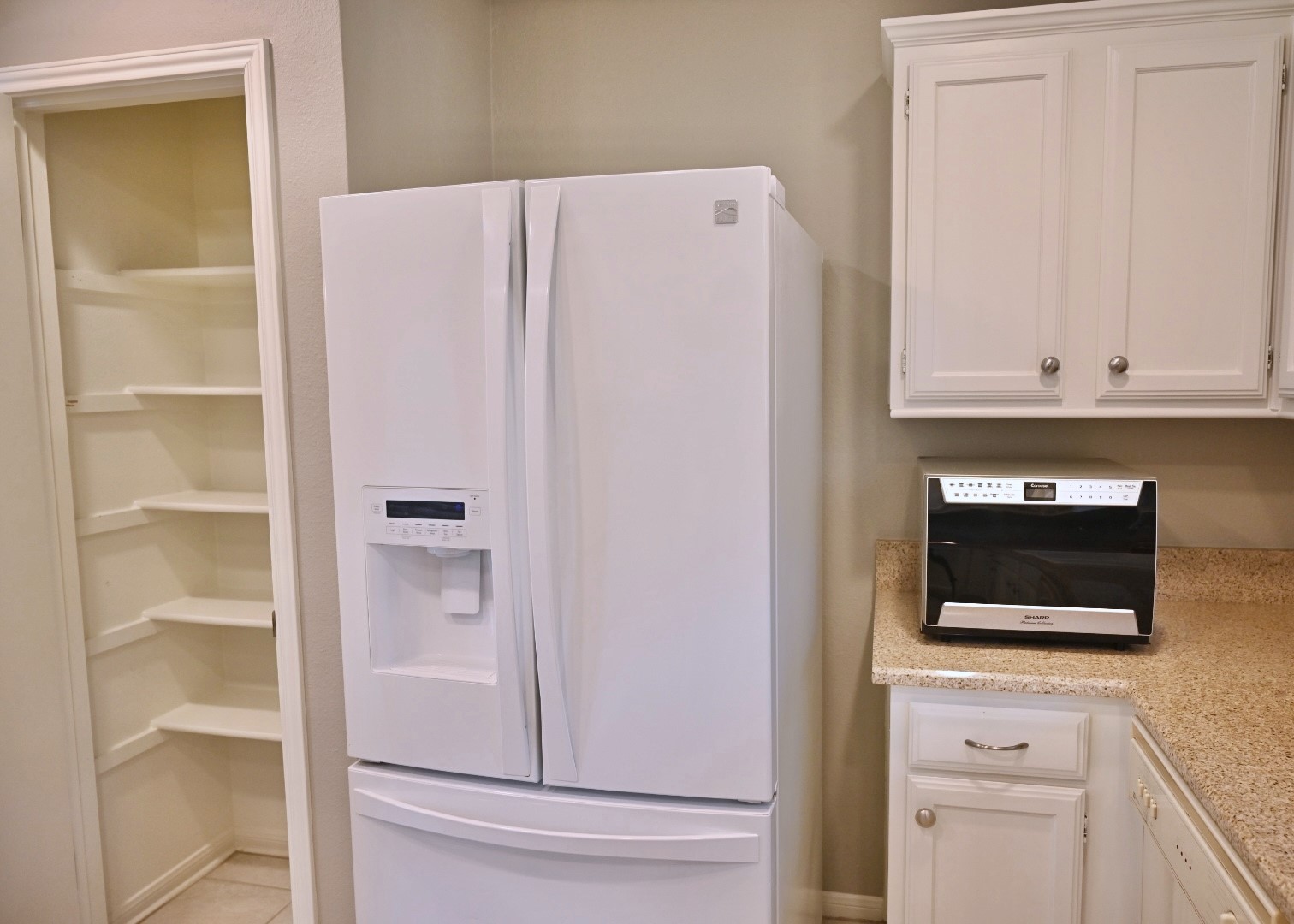 10207 Wayward Wind Lane Houston, TX 77064 - Photo 8 of 35 a room with microwave and cabinets
