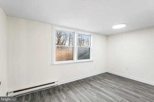 a view of an empty room and wooden floor
