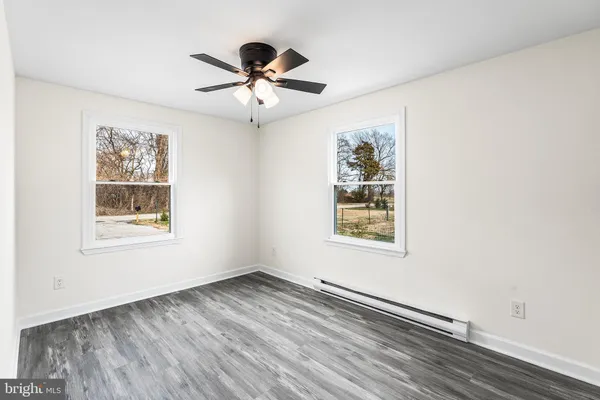 wooden floor in an empty room with a window