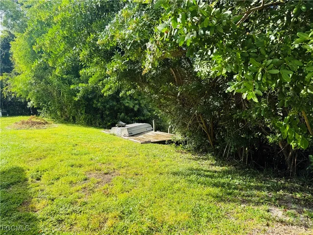 a view of yard with swimming pool and seating space