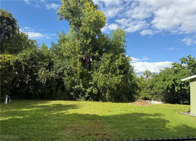 a view of a grassy field with trees