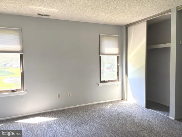 a white toilet sitting in a bathroom next to a window