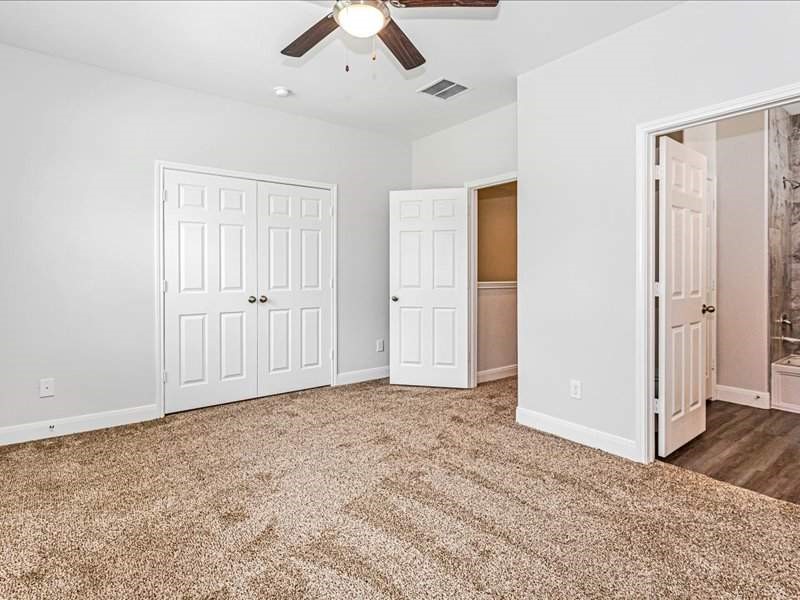 7838 Booker Street, Unit B Houston, TX 77028 - Photo 12 of 28 an empty room with closet and a ceiling fan
