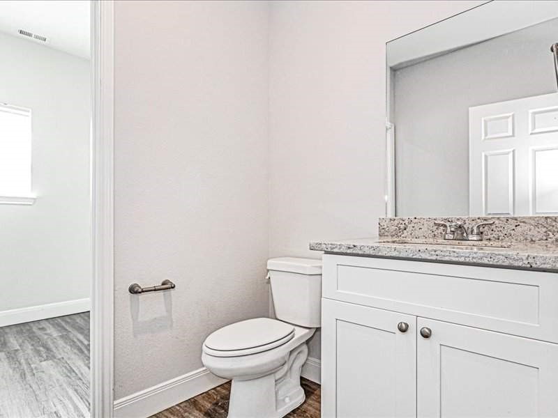 7838 Booker Street, Unit B Houston, TX 77028 - Photo 20 of 28 a bathroom with a granite countertop toilet and a sink