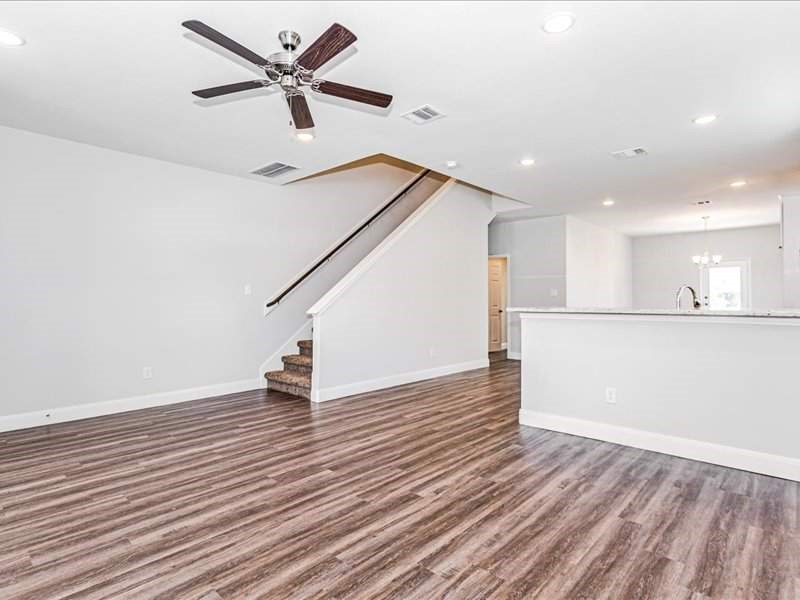 7838 Booker Street, Unit B Houston, TX 77028 - Photo 8 of 28 a view of an empty room with wooden floor and a ceiling fan