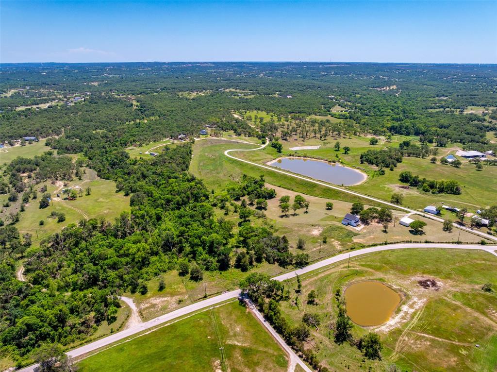 1874 County Road Springtown, TX 76082 - Photo 4 of 24 an aerial view of a residential houses with outdoor space and trees all around