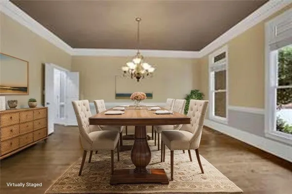 a view of a dining room with furniture a chandelier and wooden floor