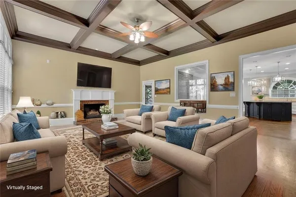 a living room with furniture a fireplace and a flat screen tv
