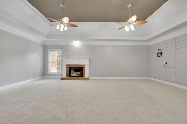 a view of an empty room with a fireplace
