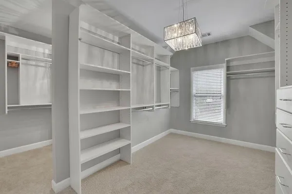 a spacious bathroom with a granite countertop tub sink and mirror