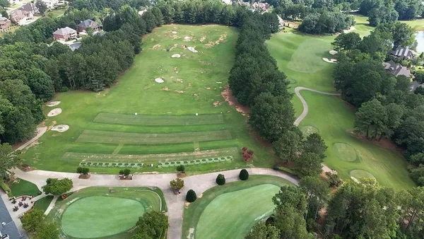 an aerial view of a house with a yard