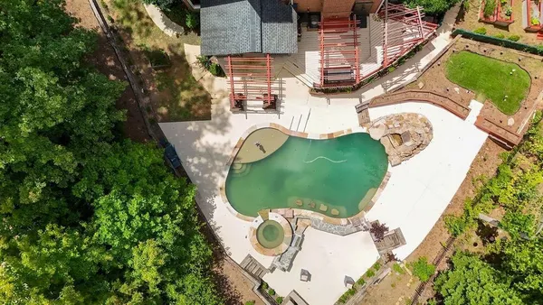 an aerial view of a swimming pool and outdoor space
