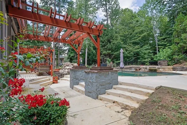 a view of swimming pool with sitting area and garden