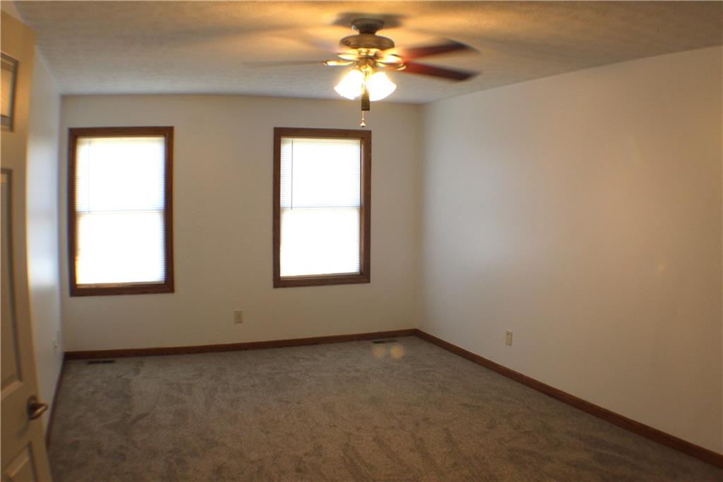 32 Intermediate Drive Coal Center, PA 15423 - Photo 18 of 36 BIG 19x12 primary bedroom with ceiling fan, fresh paint and new carpeting.