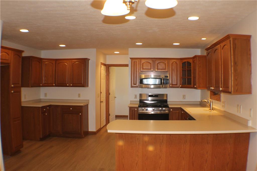 32 Intermediate Drive Coal Center, PA 15423 - Photo 9 of 36 Plenty of Oak Cabinetry in the Kitchen. Peninsula seating. New laminate flooring.
