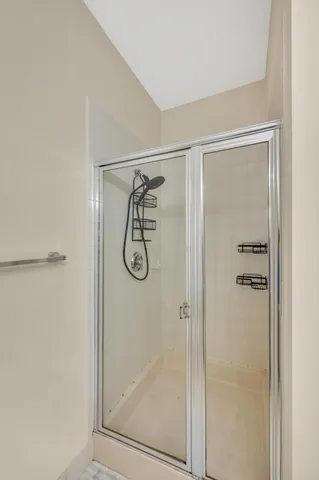 a bathroom with a glass shower door