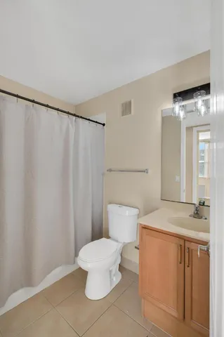 a white toilet sitting next to a bathroom sink