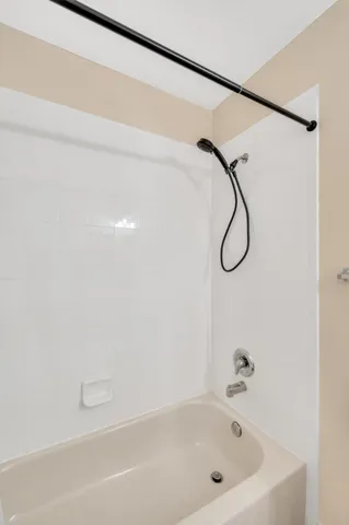 a bathroom with a bath tub with a shower