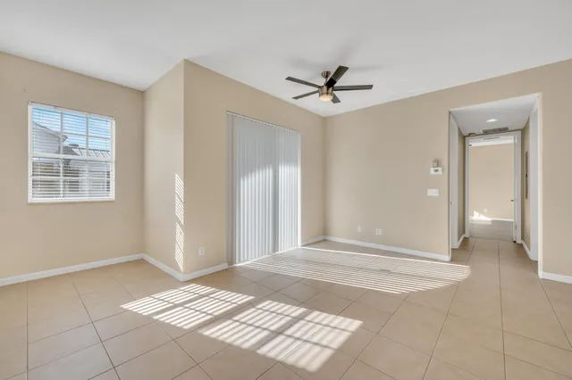 a view of a livingroom with a ceiling fan and window