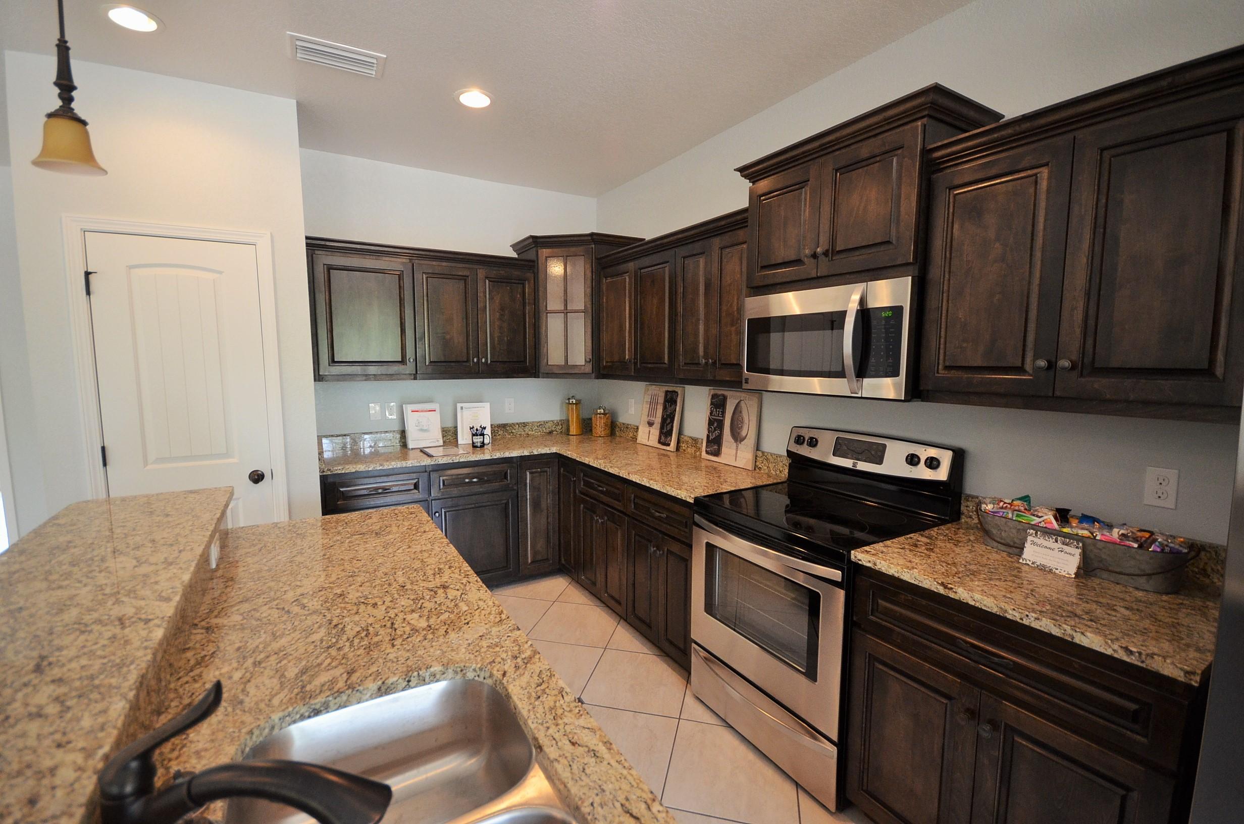 3944 Painter Branch Road Crestview, FL 32539 - Photo 8 of 21 a kitchen with stainless steel appliances stove microwave refrigerator and cabinets