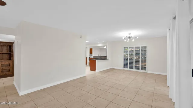 a view of an empty room with a kitchen
