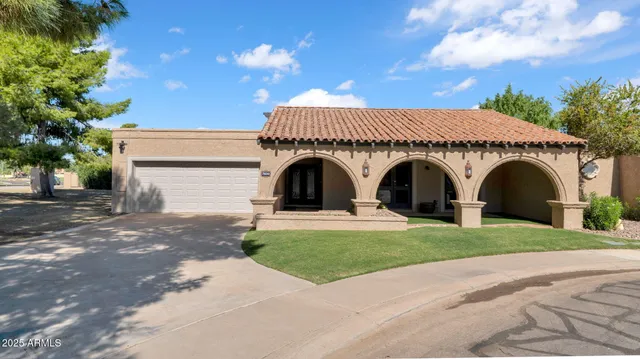 a view of a house with a yard and a garage