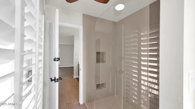 a bathroom with a granite countertop shower and a mirror