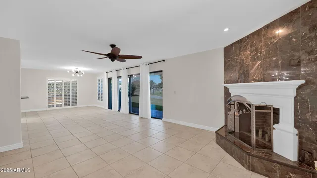 a view of a livingroom with a fireplace and window