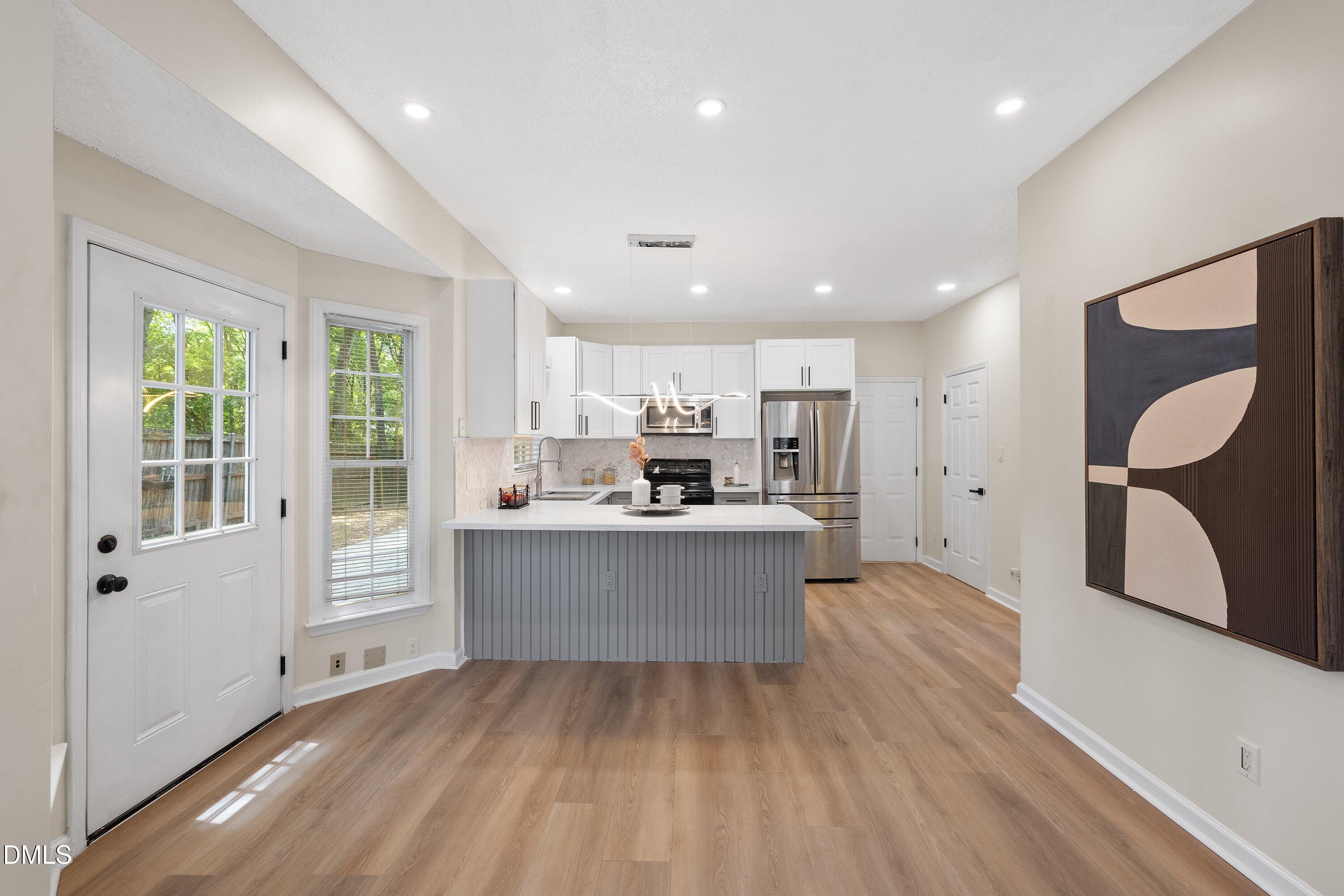 2517 Birchford Court Raleigh, NC 27604 - Photo 22 of 63 a large kitchen with a lot of counter space and windows