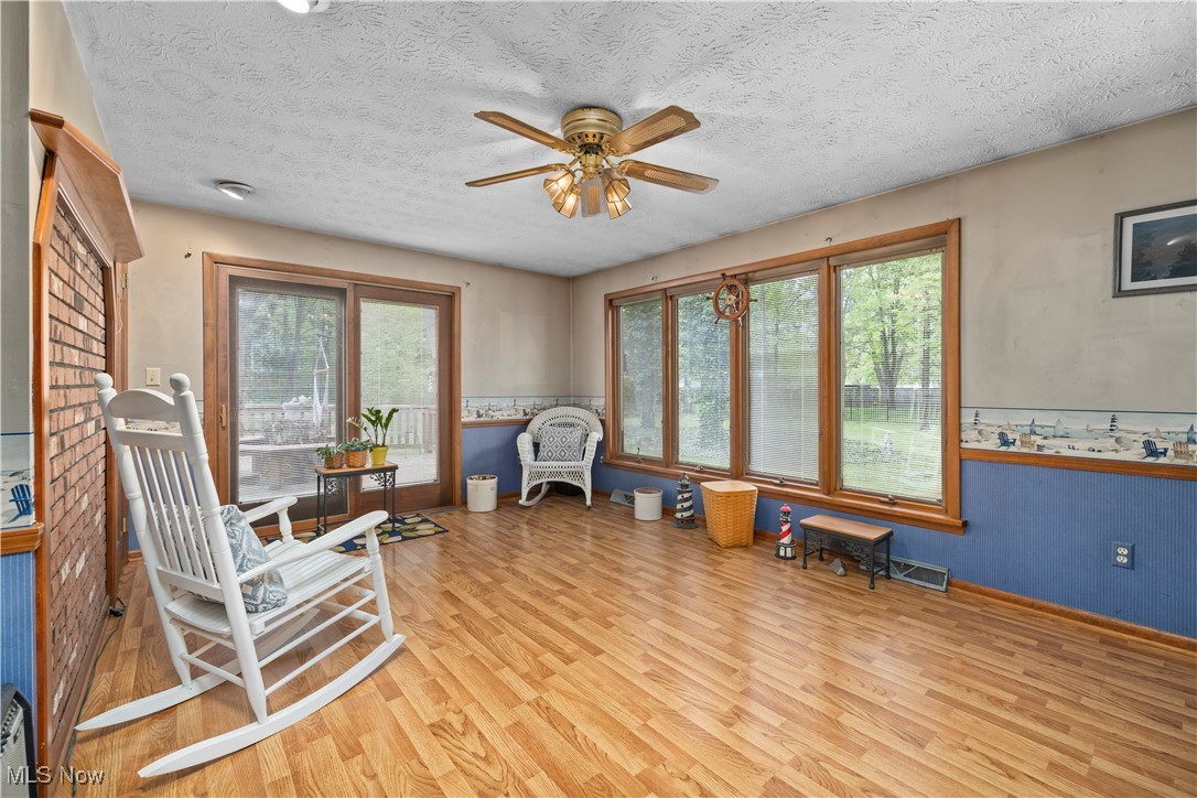 11811 Robson Road Grafton, OH 44044 - Photo 19 of 50 Living area featuring wood finished floors, a ceiling fan, plenty of natural light, a textured ceiling, and baseboards