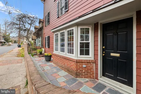 a living room with furniture and floor to ceiling windows