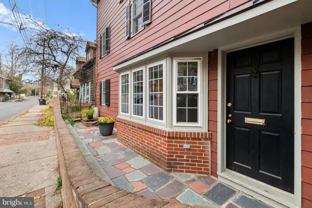 a front view of a house with a street