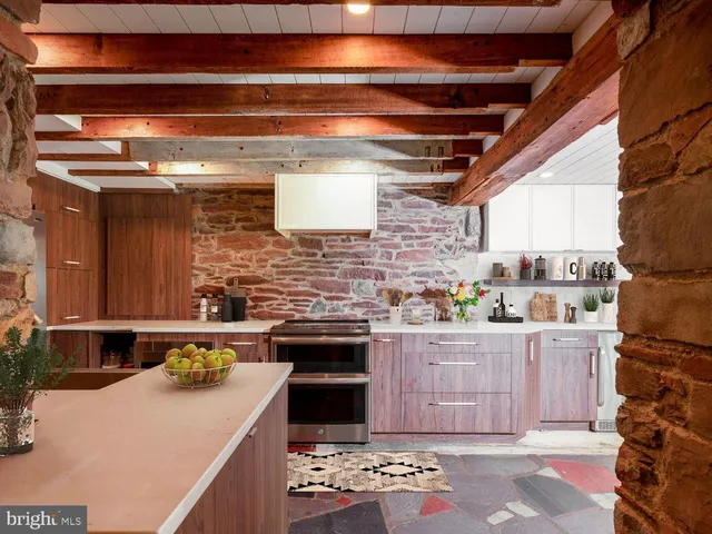 a view of a kitchen with a sink and wooden cabinets