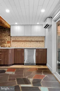 a backyard of a house with a table and chairs