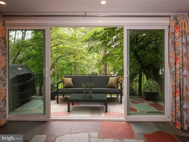 a living room with furniture and a floor to ceiling window
