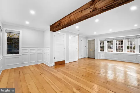 a living room with furniture and a book shelf