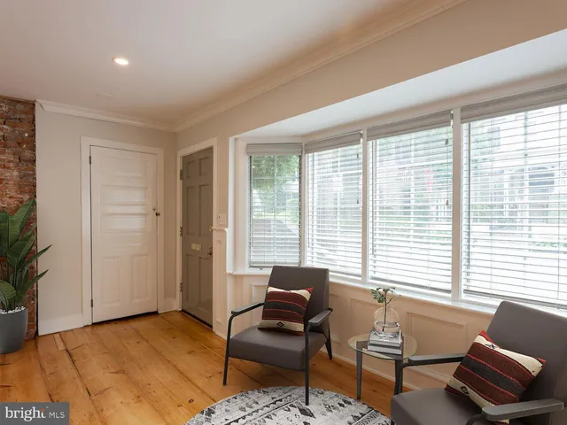 a living room with furniture and floor to ceiling windows