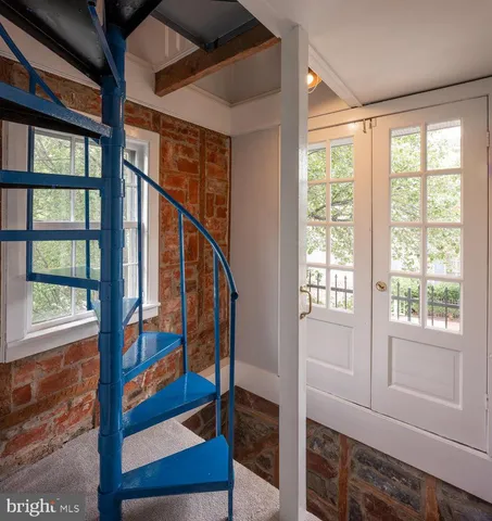 a view of an entryway with wooden floor