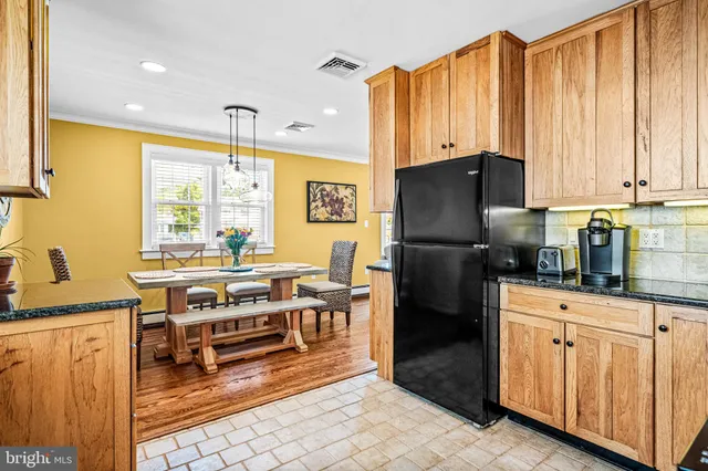 a kitchen with stainless steel appliances a stove refrigerator sink and cabinets