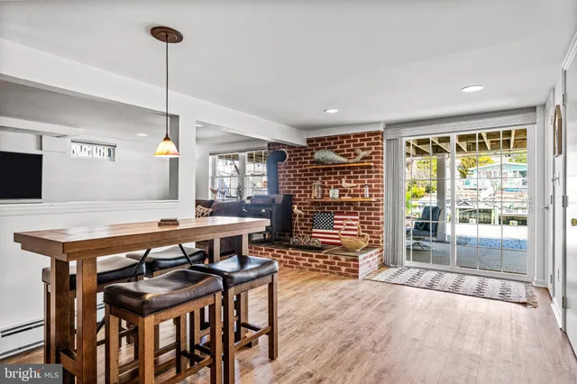 a dining room with furniture and wooden floor