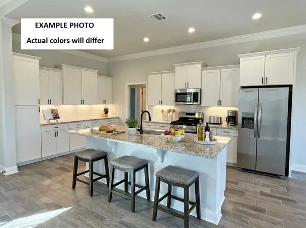 a kitchen with stainless steel appliances granite countertop a stove refrigerator sink and cabinets