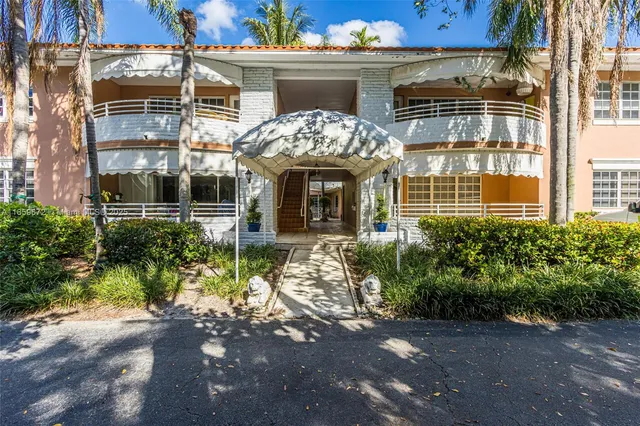 a view of a house with a swimming pool and sitting area
